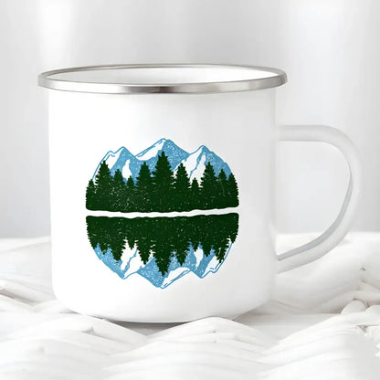 White enamel mug featuring a mountain and forest design for wanderlust camping lovers