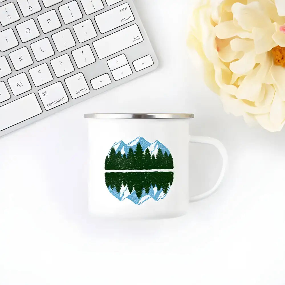 White enamel mug featuring mountain and forest design perfect for wanderlust camping