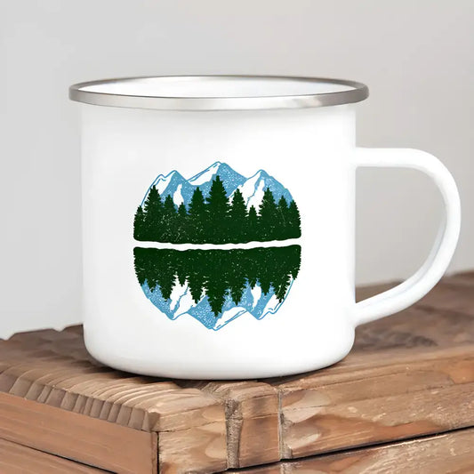 White enamel mug featuring a mountain and forest design, perfect for wanderlust camping