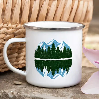 White enamel mug with mountain and forest design for wanderlust camping adventures