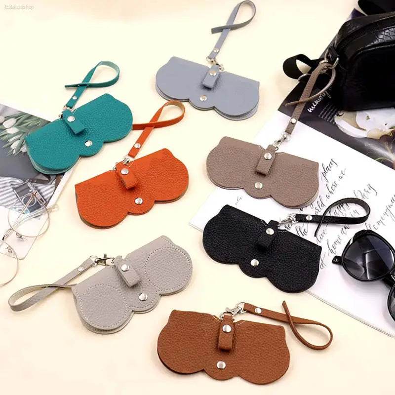 Colorful leather glasses cases with wrist straps.