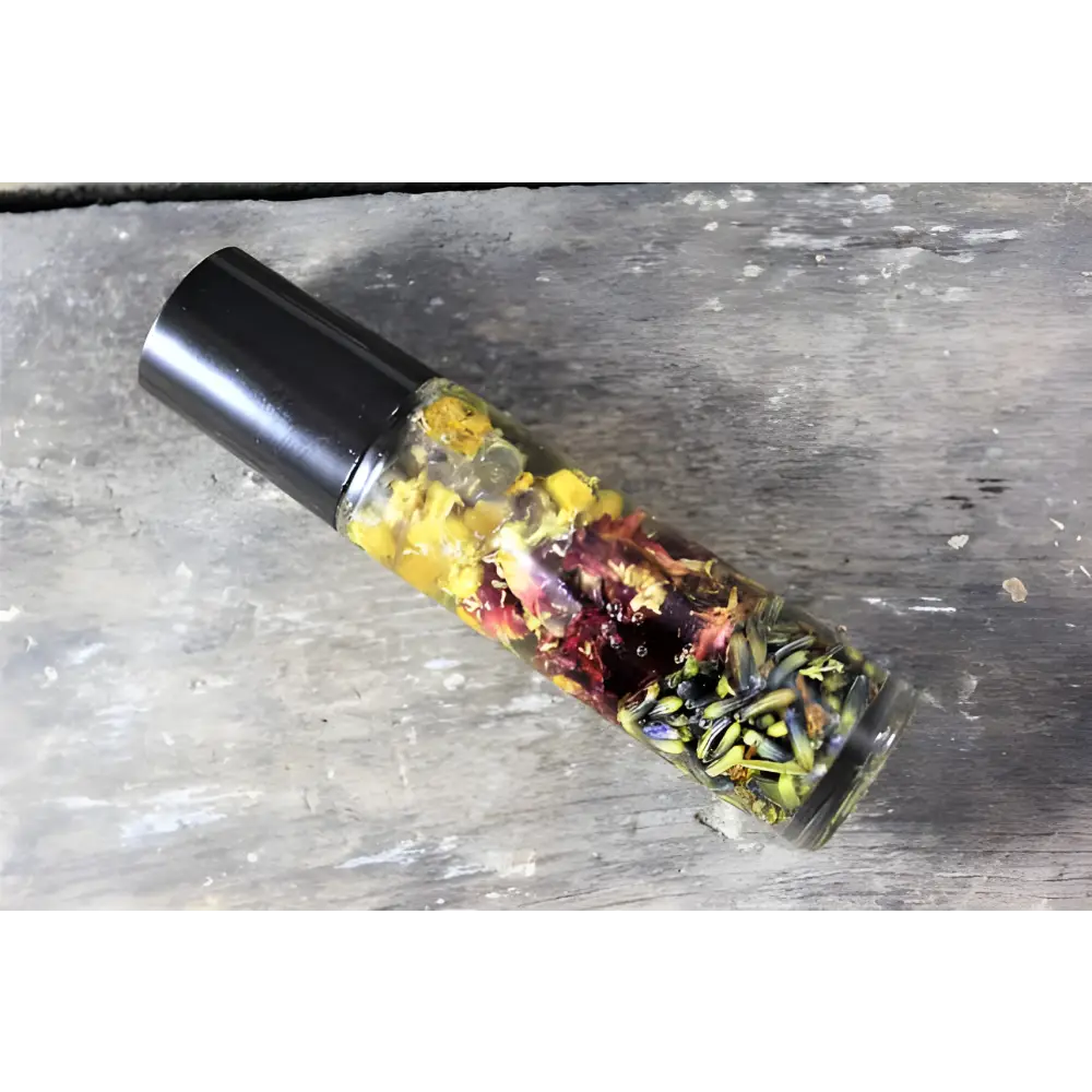 Aromatic oil roller bottle with dried flowers for a natural essential oil perfume blend