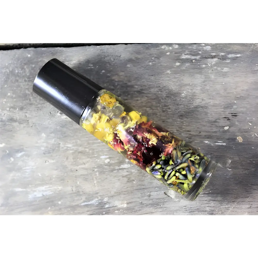 Aromatic oil roller bottle with dried flowers for a natural essential oil perfume blend