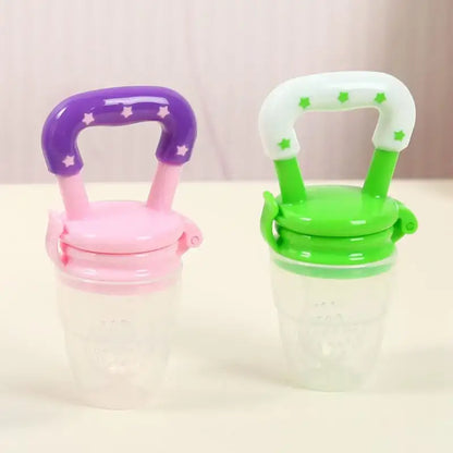 Two colorful Fresh Food Nibbler baby pacifiers feeders for safe eating