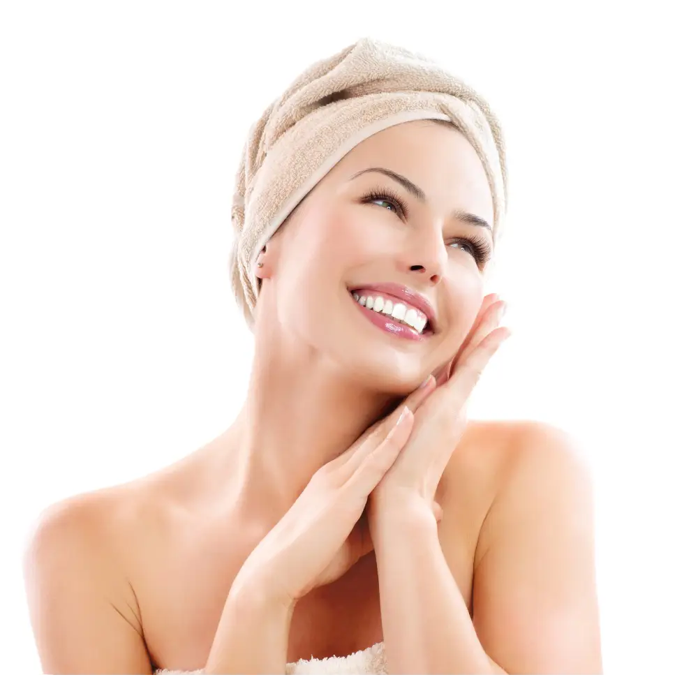 Smiling woman with towel-wrapped hair using Pomegranate Floral Gel Toner for glowing skin