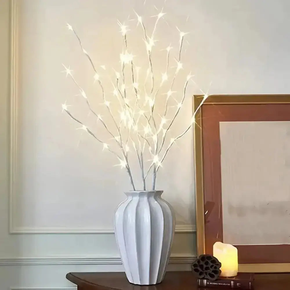 Illuminated white birch branch lights in a chic white vase for cozy decor