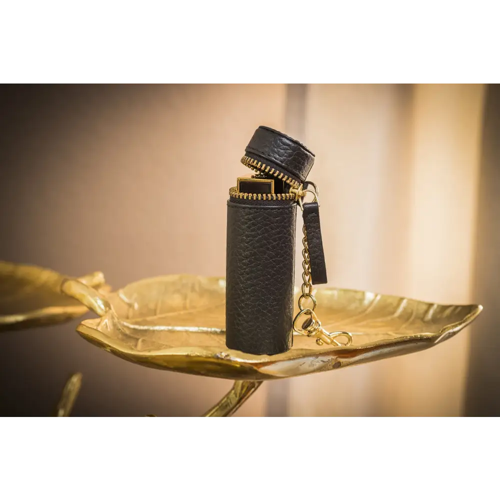 Black leatherette lipstick keeper with gold zipper and chain for stylish storage