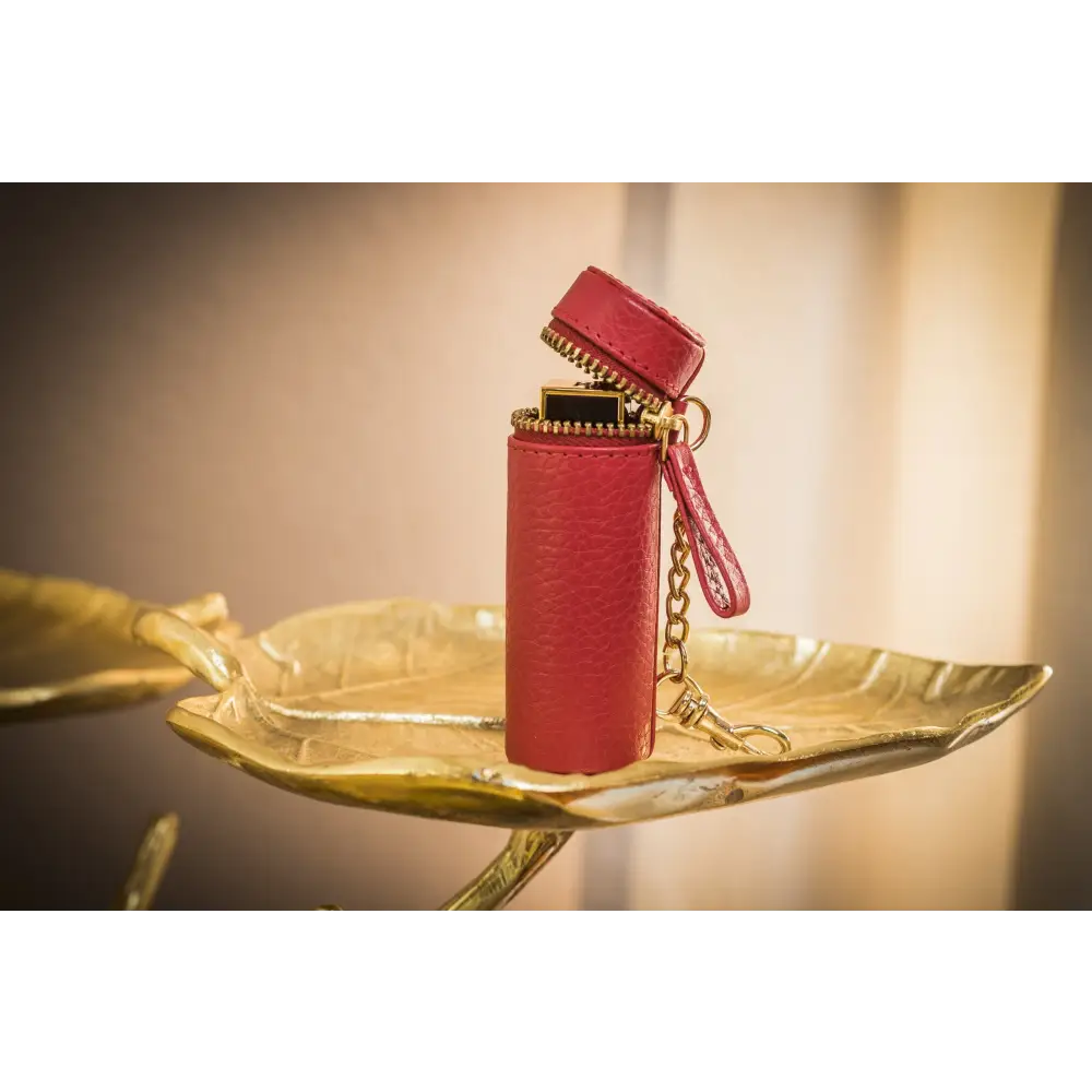 Red leatherette lighter case with gold zipper, a stylish lipstick keeper