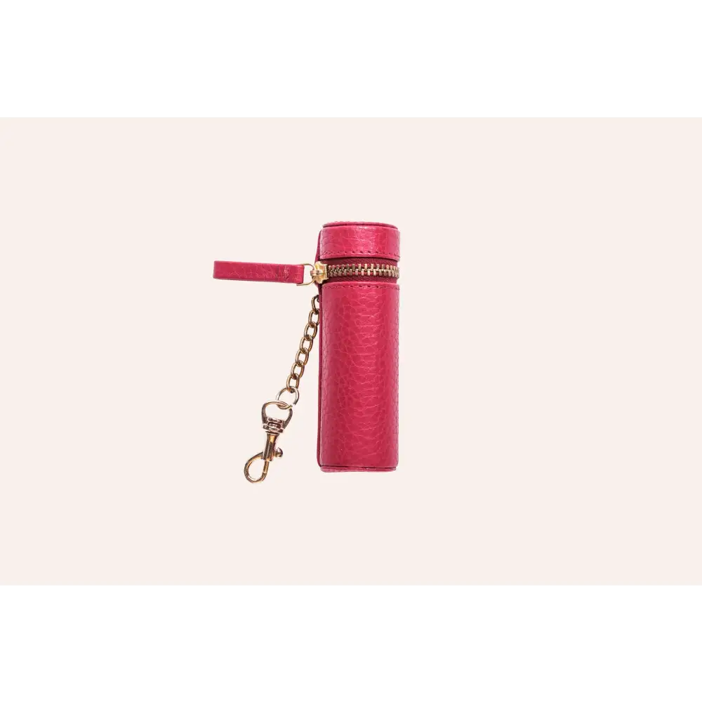 Cylindrical pink leather lipstick keeper with gold zipper and chain for easy access