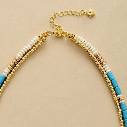 Beaded necklace featuring gold seed beads and turquoise for a stylish look