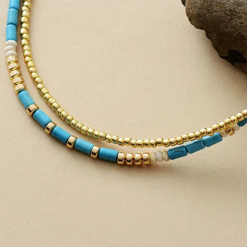 Two-strand beads necklace featuring Gold Seed Beads and turquoise accents