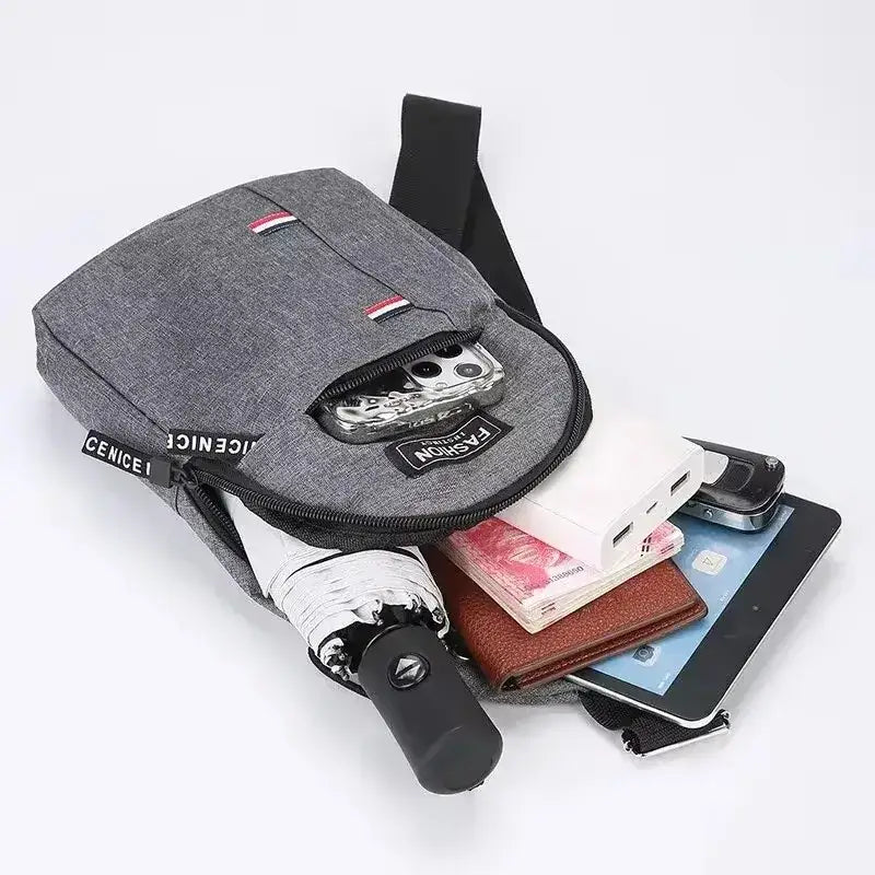 Gray sling bag showcasing contents, perfect as a large crossbody bag for men