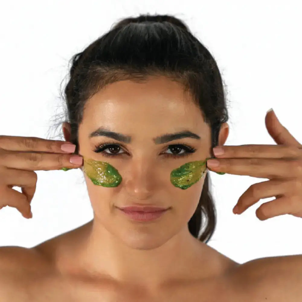 Woman applying a detoxifying exfoliating mask from the Green Smoothie Detoxifying Exfoliating Trio