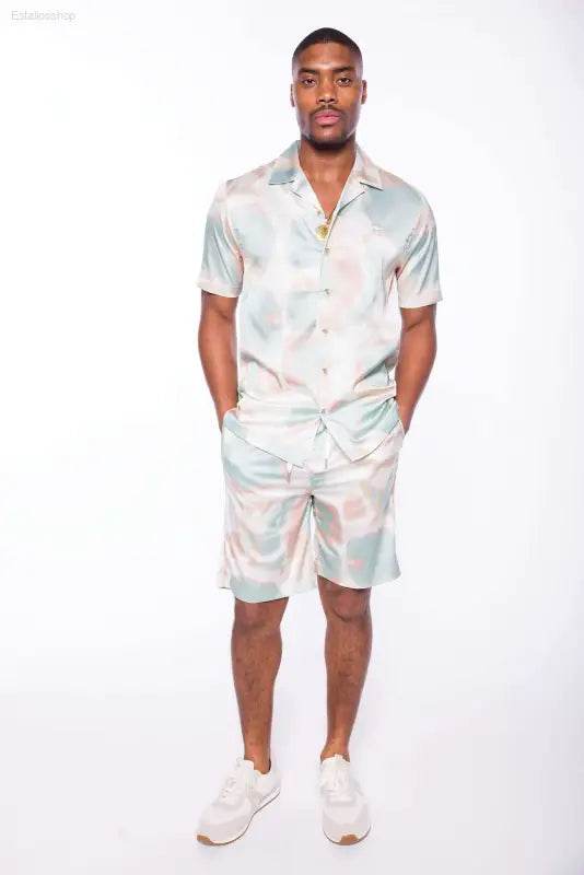 Man in patterned shirt and shorts.