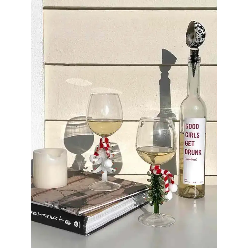 Festive handblown Christmas tree wine glasses with a stylish wine bottle