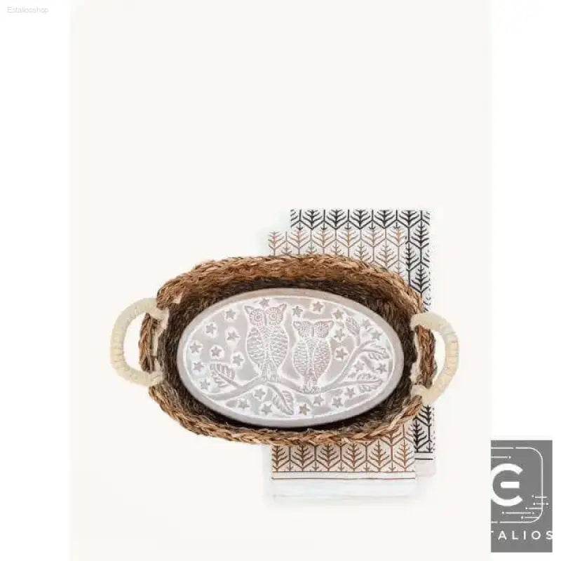 Oval owl-themed tray in a woven basket.