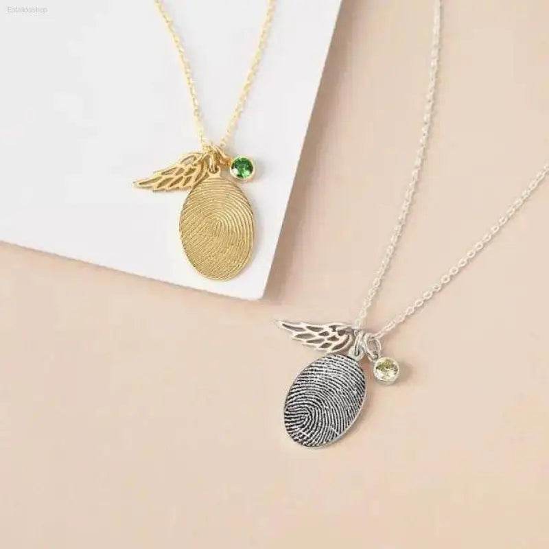 Two fingerprint necklaces.
