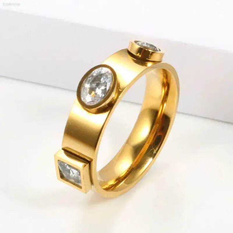 Gold ring with three embedded gemstones.
