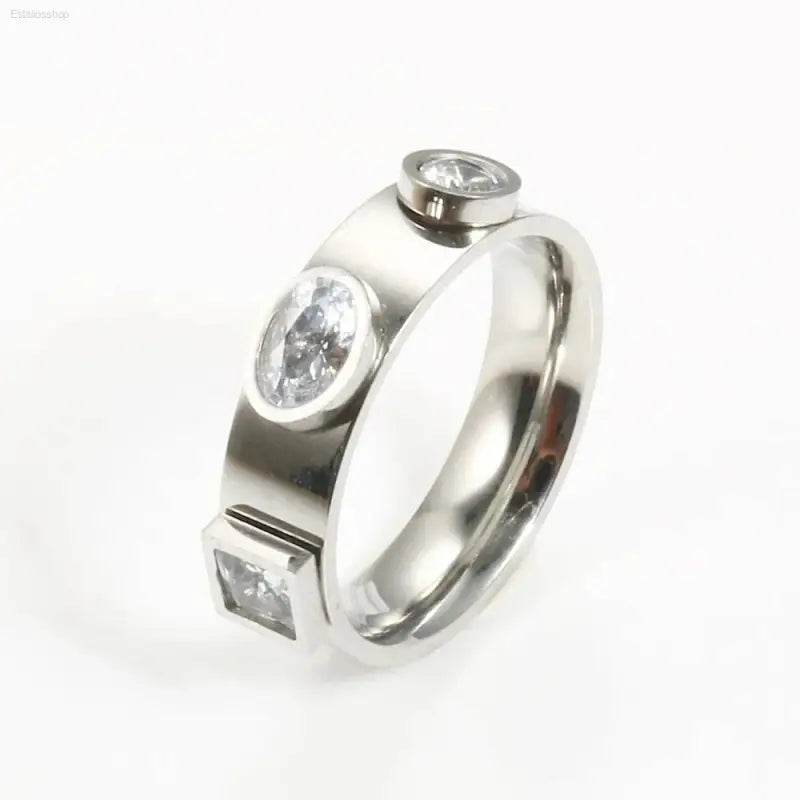 Silver ring with three embedded gemstones.