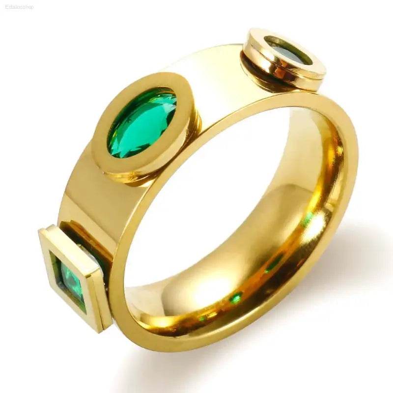 Gold ring with green gemstones.