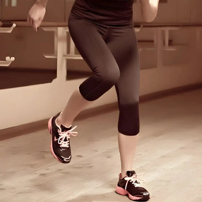 Woman wearing Lauma Active Capri leggings while exercising in athletic wear