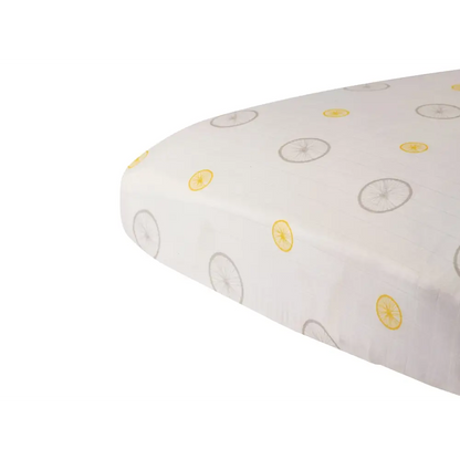 White bamboo muslin crib sheet with lemon and bicycle prints for vintage charm