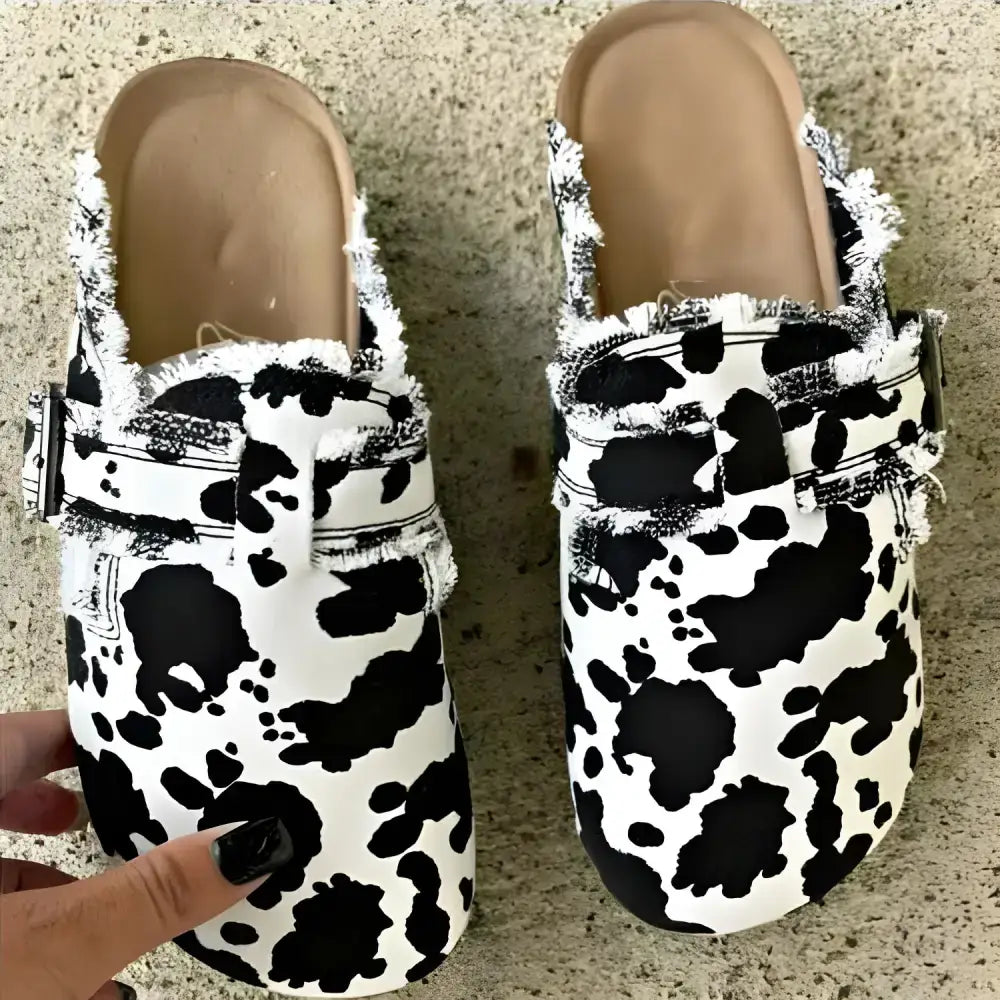 Cow-print clogs with fringed trim, perfect flat heel round toe footwear for trendy outfits