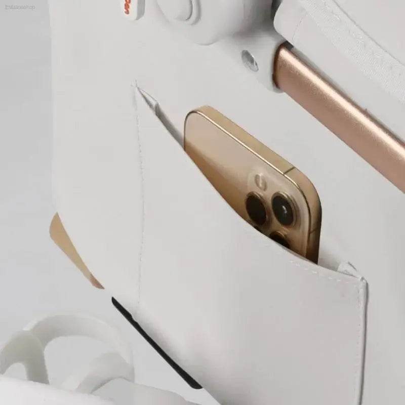 White bag with phone in pocket.