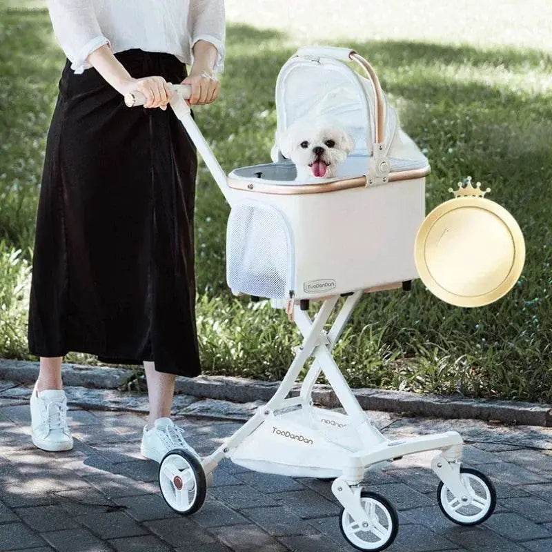 White dog stroller with a small dog inside.