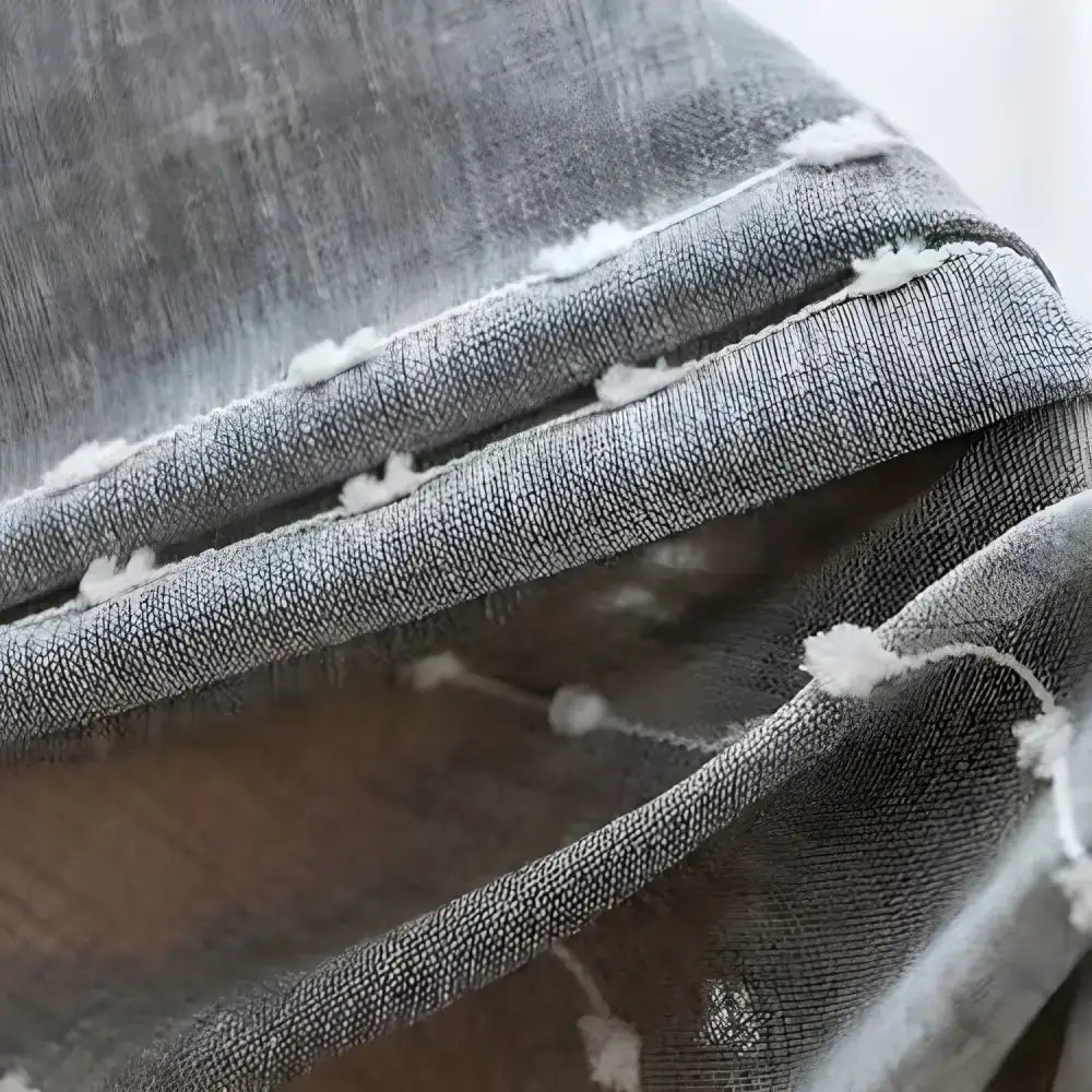 Gray textured fabric with white pom-poms in elegant embroidered ball linen curtains