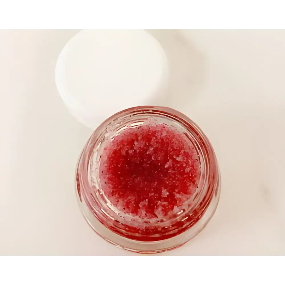 Red lip scrub in a clear jar of Luscious Organic Coconut Lip Scrub, completely edible treat