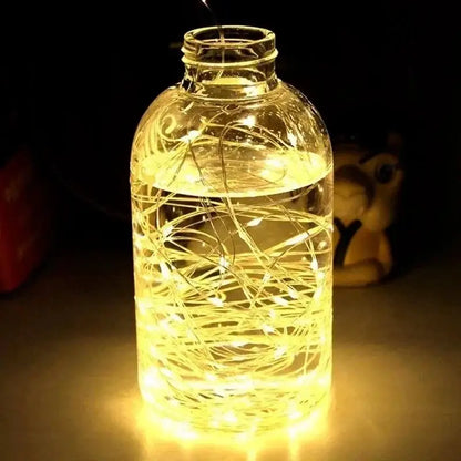 Illuminated glass bottle with USB LED string and silver wire garland lights inside