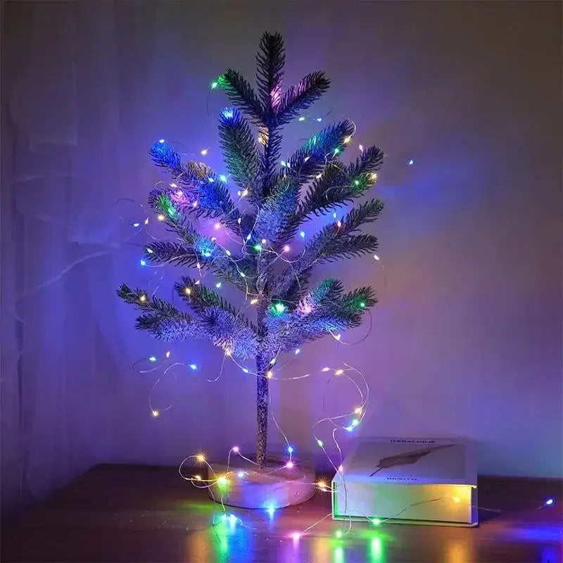 Small Christmas tree glowing with USB LED string lights in Magical USB LED Fairy Light Cloches