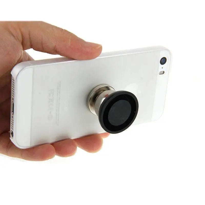 White smartphone with lens attached to Magnetic Phone Holder Mount Dash in a car