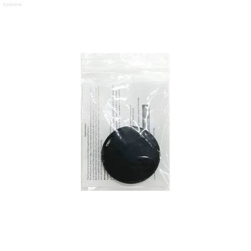 Black circular adhesive pad in plastic packaging.