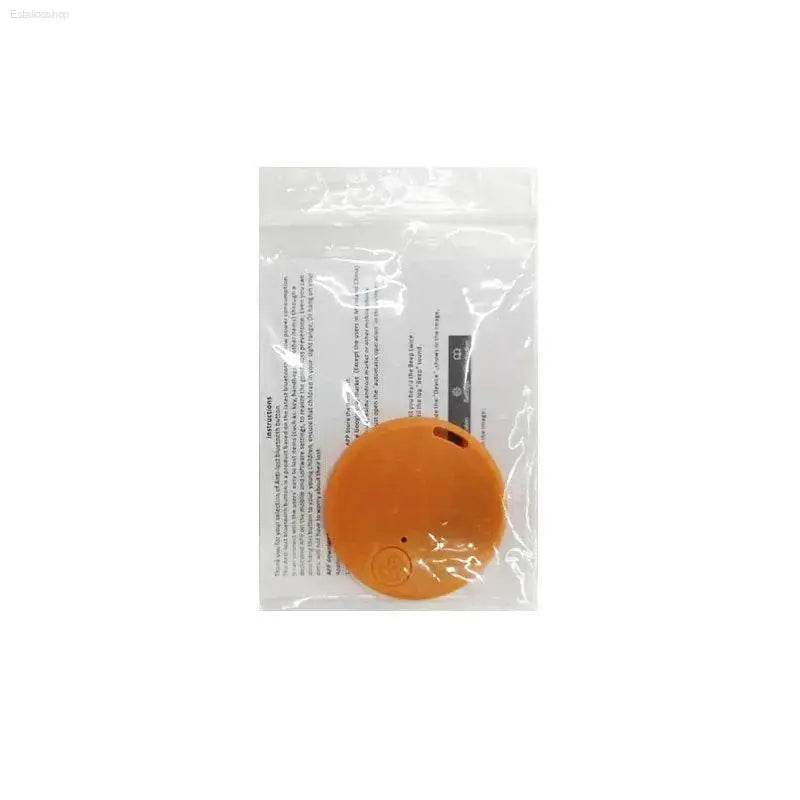 Orange circular tracker in packaging.