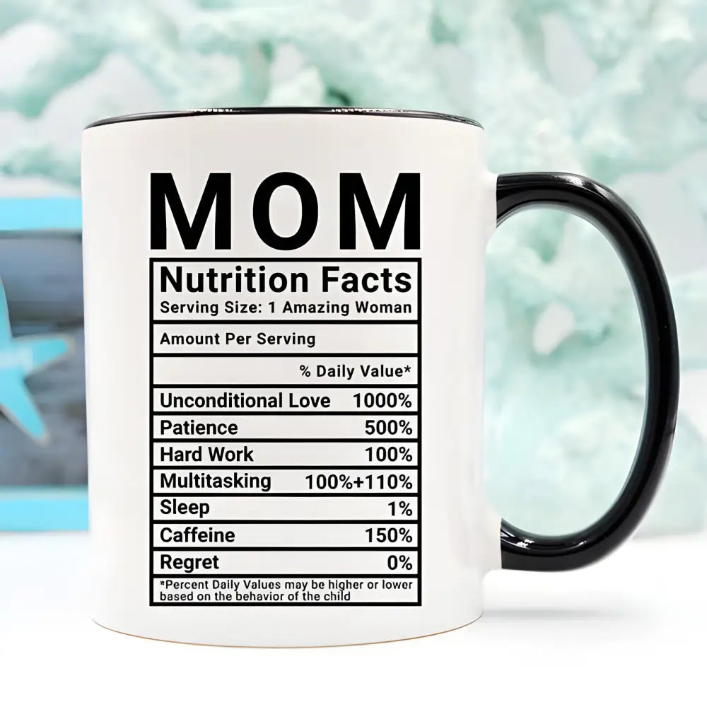 White coffee mug with black trim featuring Mom Nutrition Facts funny coffee mug design