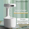 White anti-gravity humidifier with digital clock.