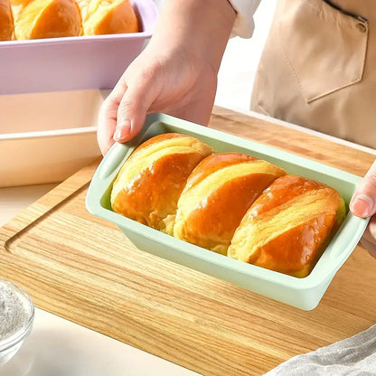 Freshly baked bread in a green nonstick silicone loaf pan, perfect for Christmas cookies