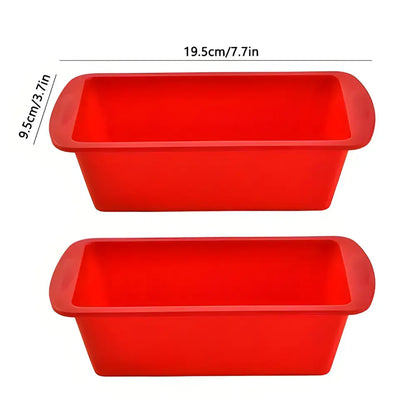 Two red nonstick silicone loaf pans ideal for baking Christmas cookies effortlessly