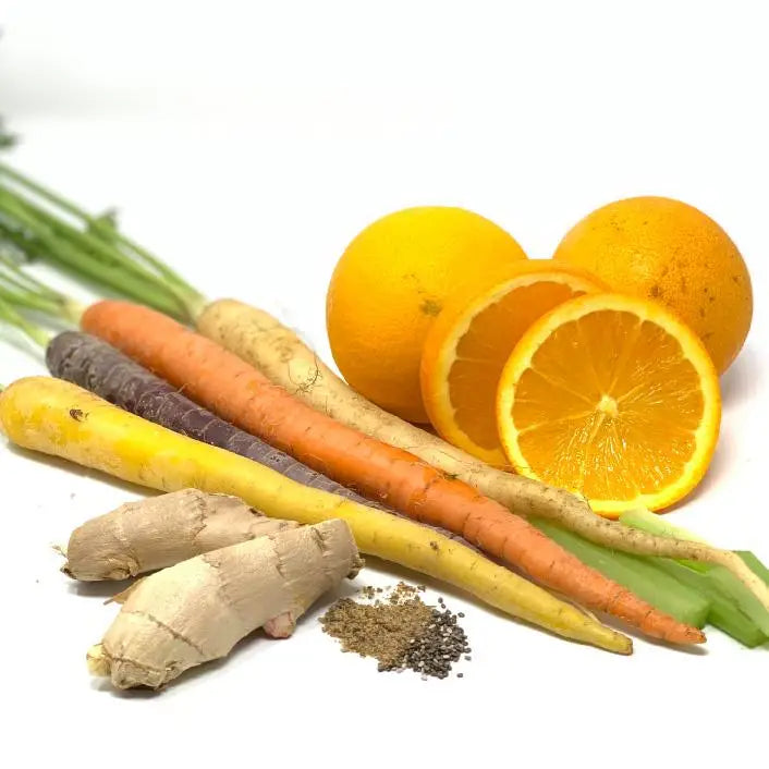 Colorful produce arrangement featuring refreshing carrot and orange peel brightening exfoliating mask