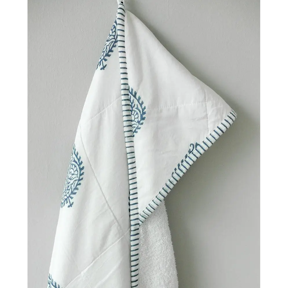 White hooded baby towel with blue floral pattern, perfect for a cozy towel fort