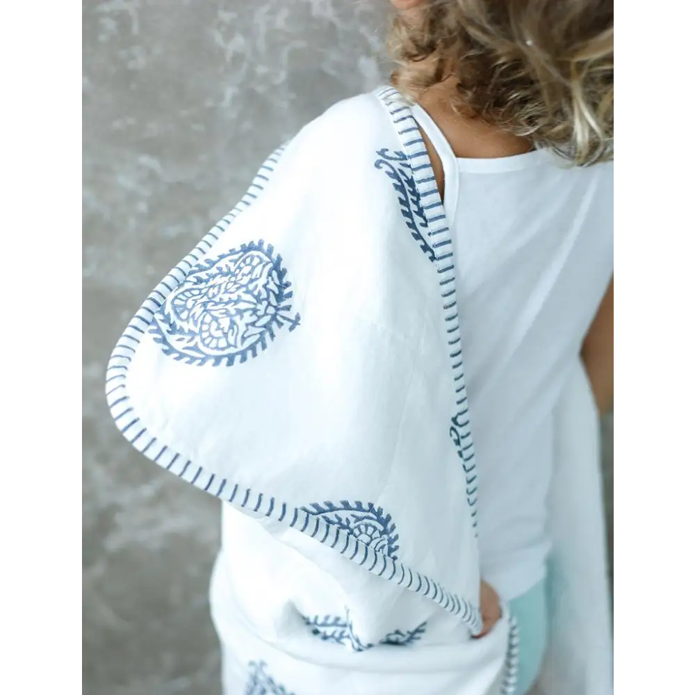 White shawl with blue paisley print for a cozy towel fort vibe. Perfect for playtime!