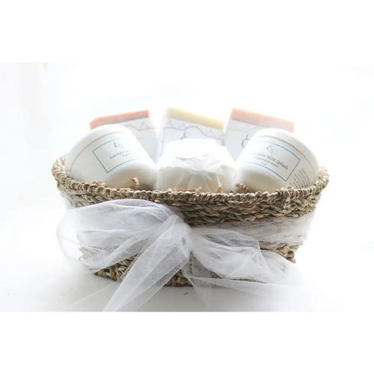 Wicker gift basket filled with soaps and candles for smooth skin pamper gifts