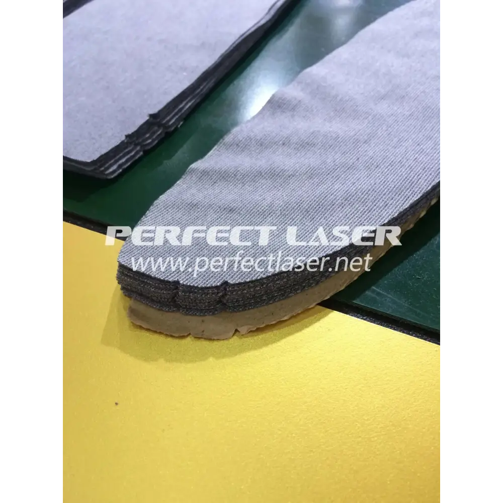 Stacked shoe insoles being cut with a Perfect Laser Automatic Fabric CNC Cutter