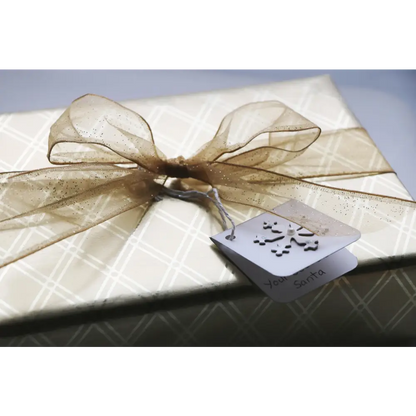 Wrapped gift with sheer ribbon and snowflake tag for the Perfect Mother’s Day Soap Sampler Gift