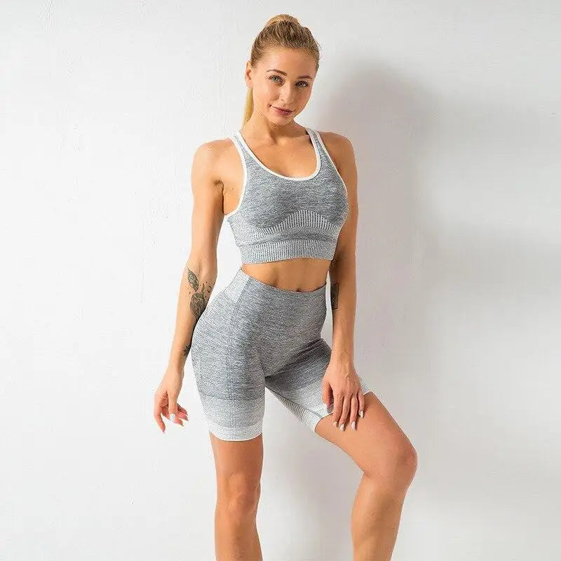 Woman in gray athletic wear from the Pink & Gray 2Pcs Set Selfie Ready