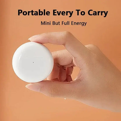 Person holding white spherical Pocket HiFi Stereo Wireless Earbuds in hand