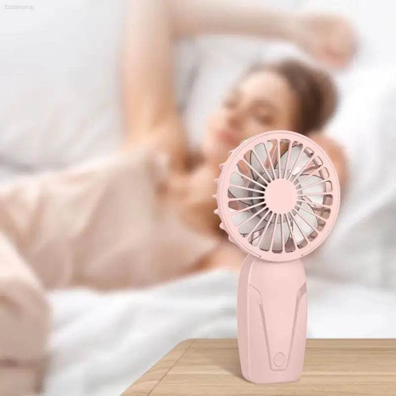 Pink handheld fan.
