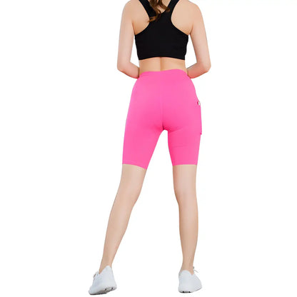 Woman in black sports bra and pink biker shorts showcasing Pocket Power Yoga Shorts